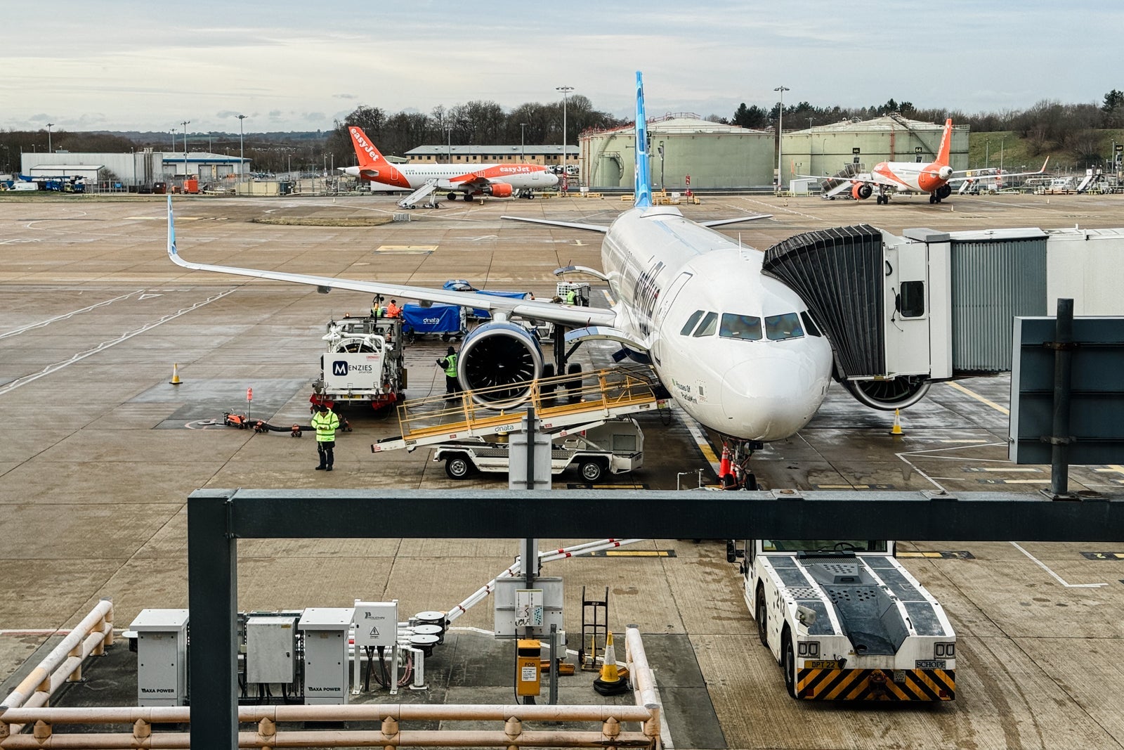 A JetBlue plan parked on the tarmac at an airport