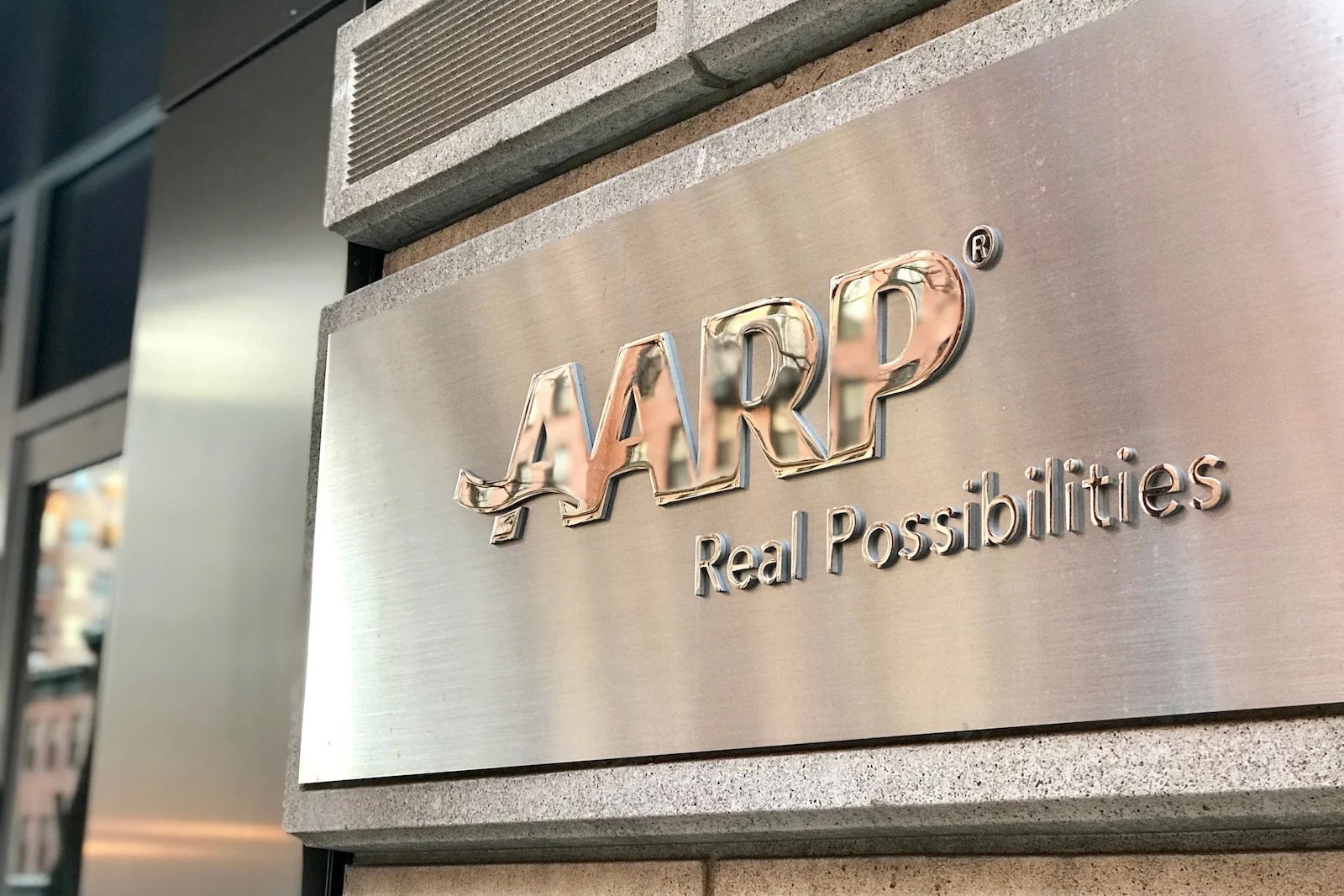 AARP logo on metal background
