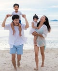 Family enjoying the beach at sunset