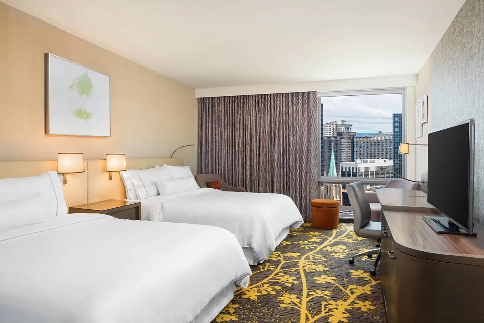 hotel room with two beds and window looking out over Cleveland