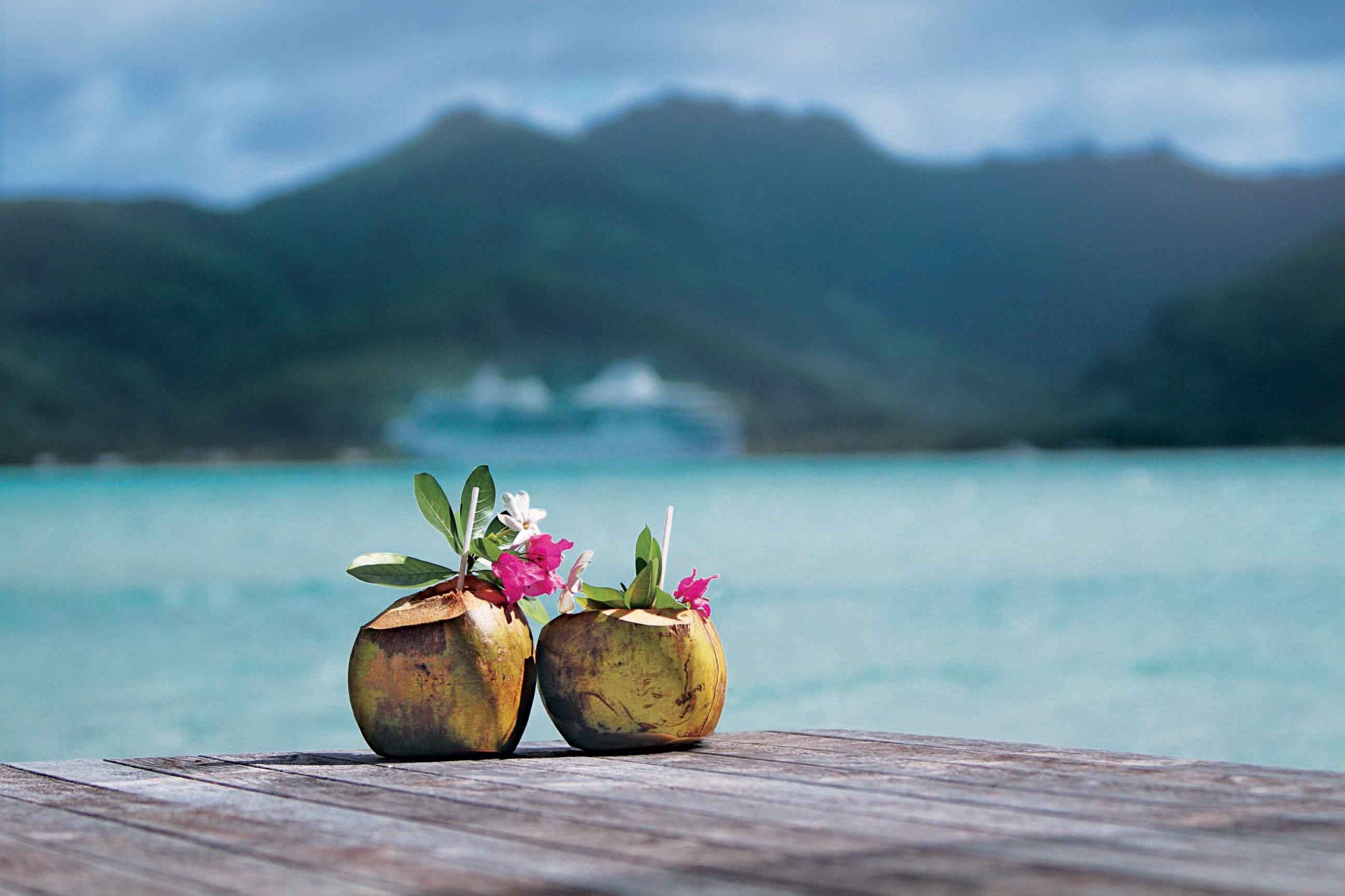 Coconuts in French Polynesia with the cruise ship Paul Gauguin in the background