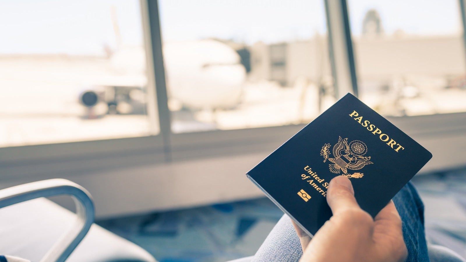 Hand holding US passport.