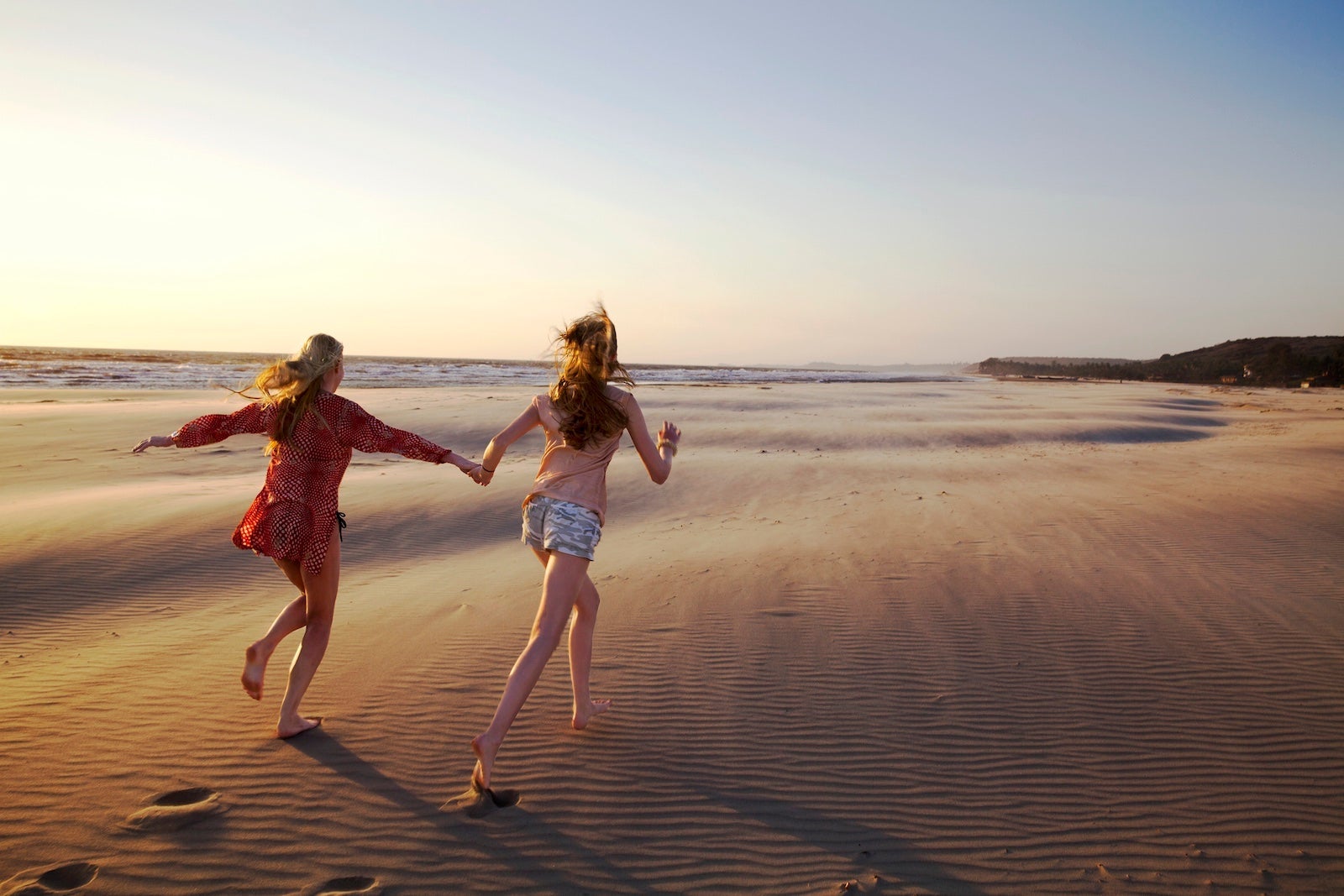 two people running down the beach