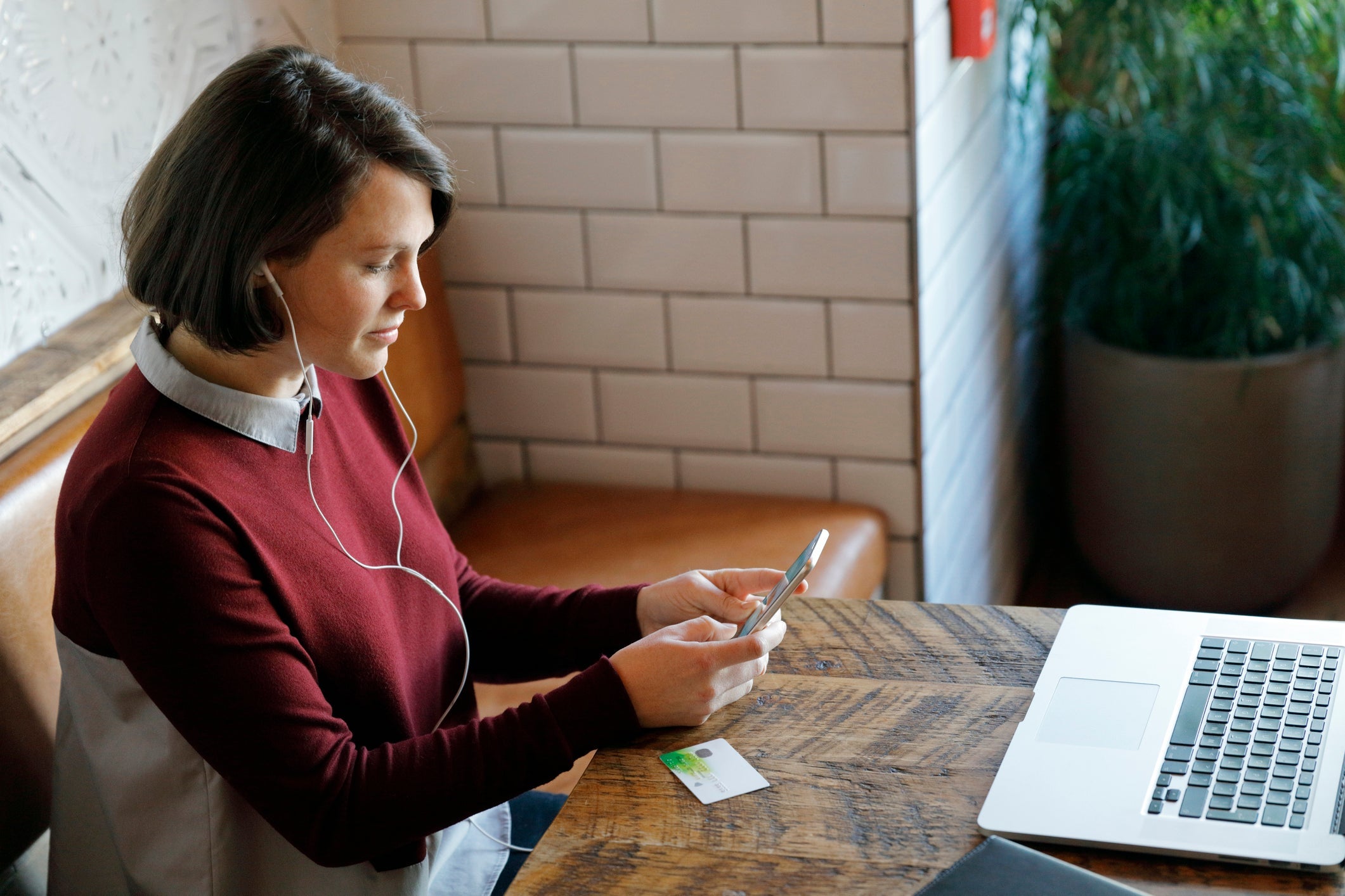 Woman making a purchase on her cell phone