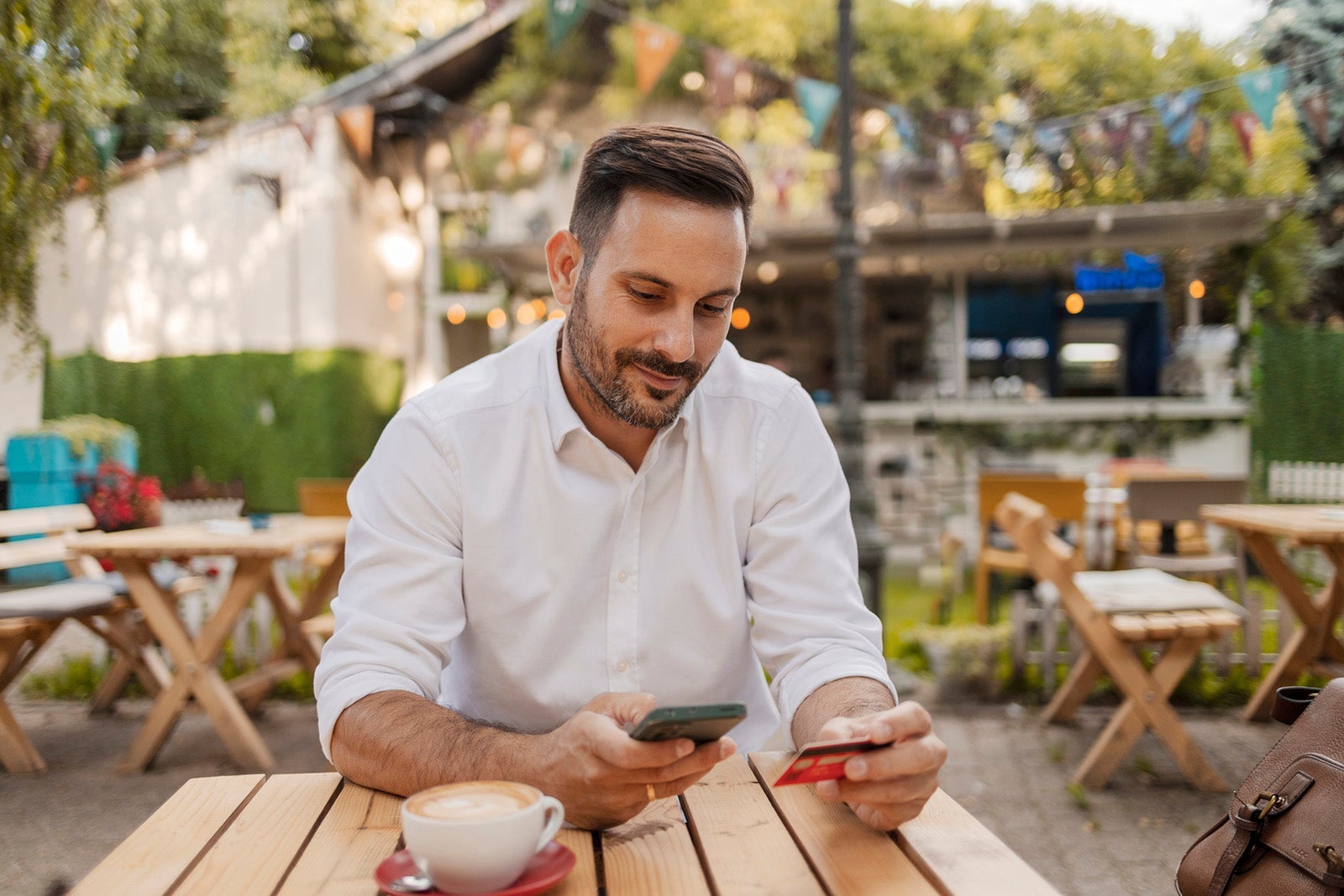 Man using phone and card