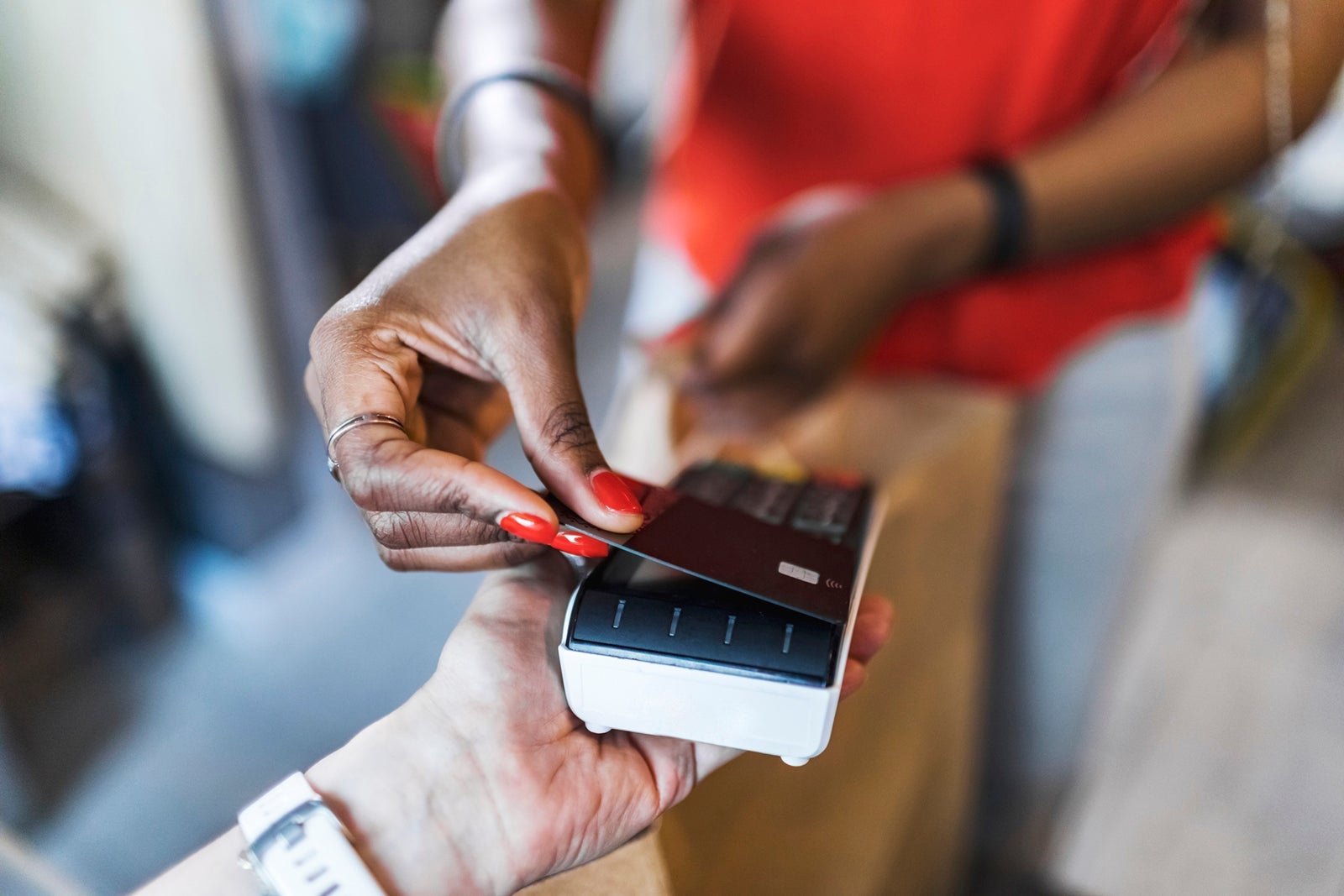 Young adult African woman shopping and paying for the purchase by credit card