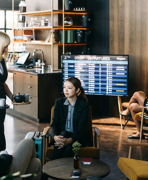 Frequent flyers enjoying the benefits and service of the first class lounge at the airport.