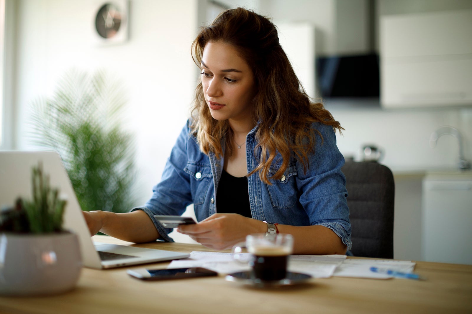 Woman paying bills at home