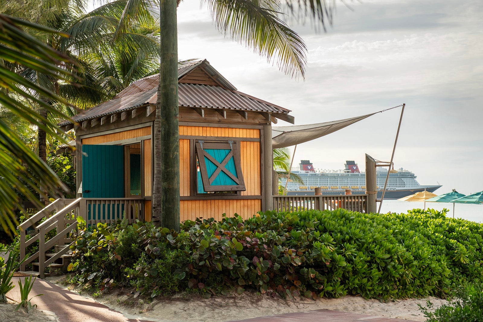 Beach cabana with Disney cruise ship in the distance