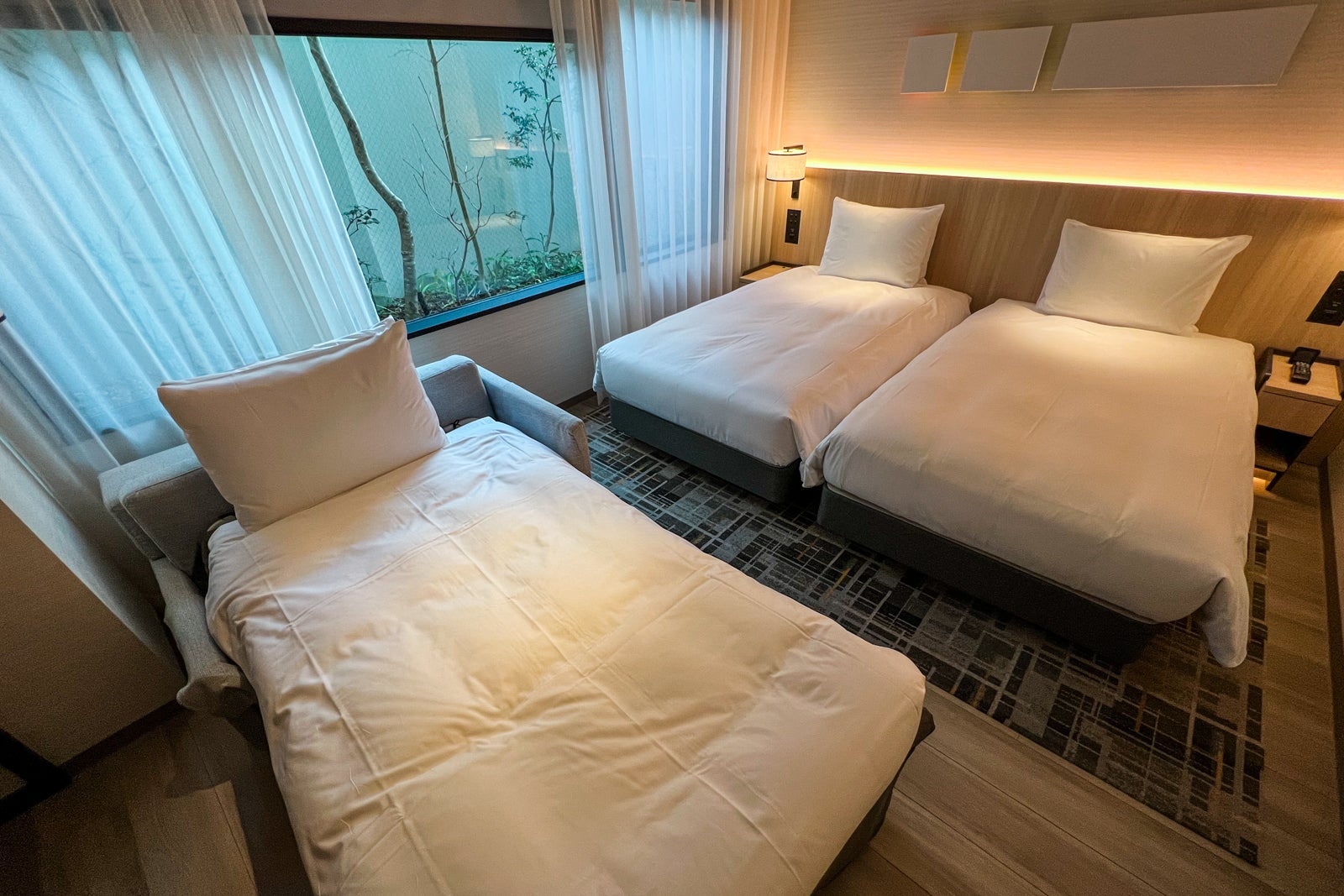 three beds in room