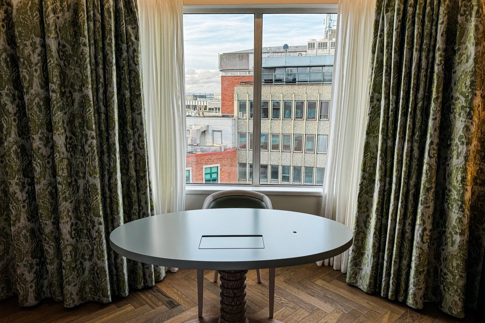 A desk by a window in a guest room at the Conrad Dublin