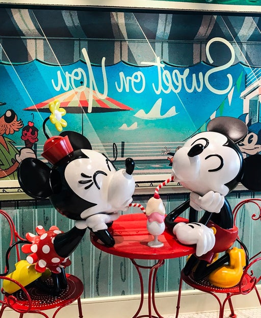 Statue of Minnie and Mickey Mouse sharing a milkshake on a Disney cruise ship