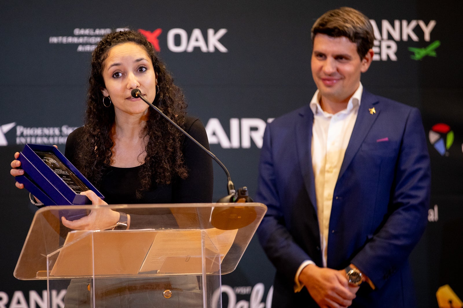 Route planning executives from Air Transat (left) and JetBlue (right) come on stage to accept the Cranky Network Awards for 'sexiest new airline routes.'
