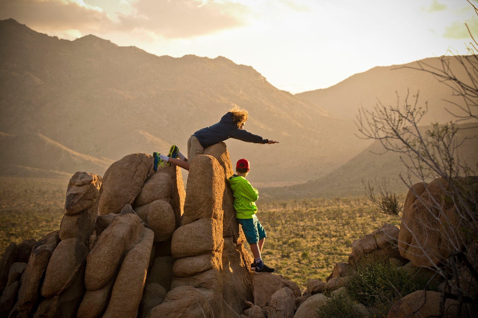 Two kids standing on rocks in Joshua Tree National Park
