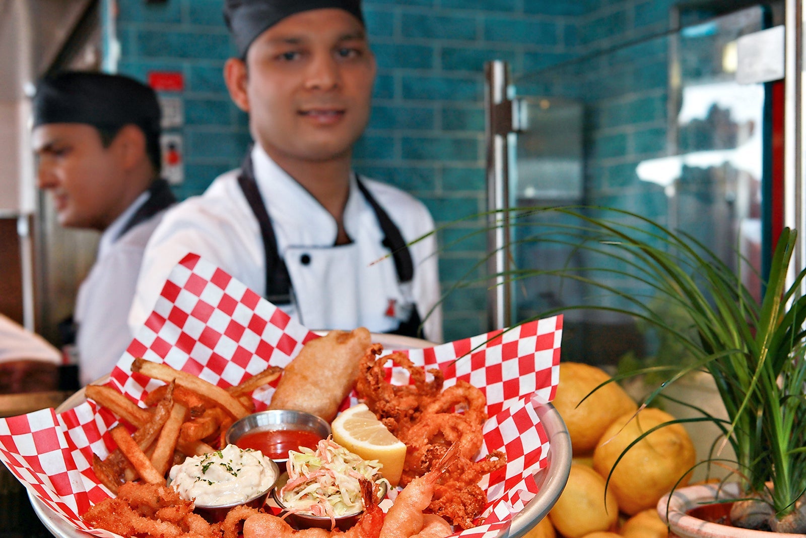 Chef delivering plate of seafood on a Carnival cruise ship