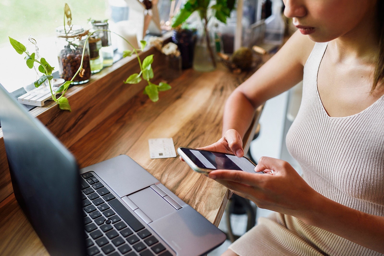 Woman's hands making credit card payment on her phone