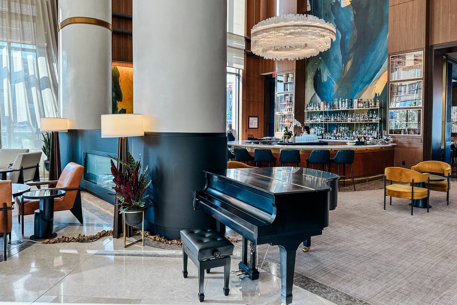 A grand piano near a bar at the Conrad Nashville