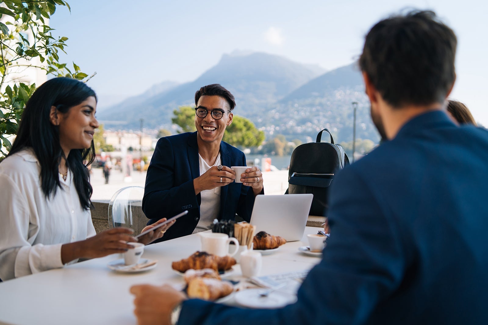People at a table chatting over coffee