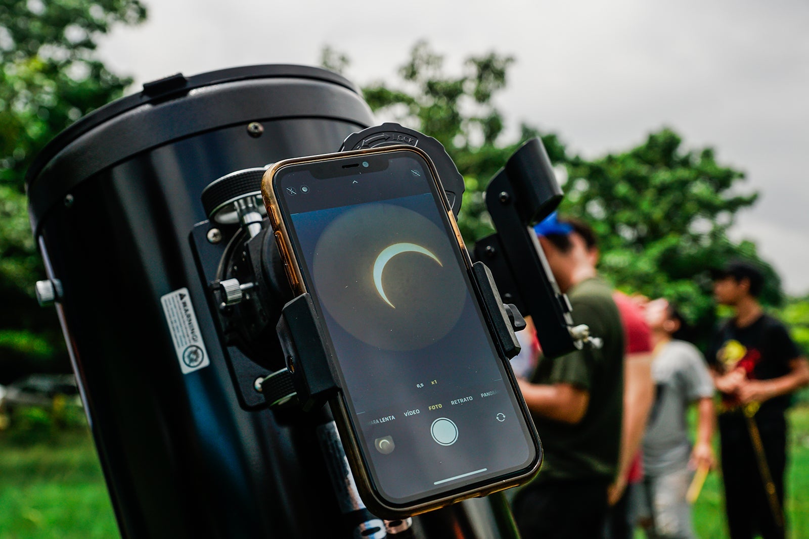SAN SALVADOR, EL SALVADOR - OCTOBER 14: Detail of the sun hidden by the moon in a mobile phone connected to a telescope during an annular solar eclipse on October 14, 2023 in San Salvador, El Salvador. According to the Salvadoran Astronomy Association (ASTRO), the eclipse extends in several phases throughout the day and visible throughout the country. APHOTOGRAFIA/GETTY IMAGES