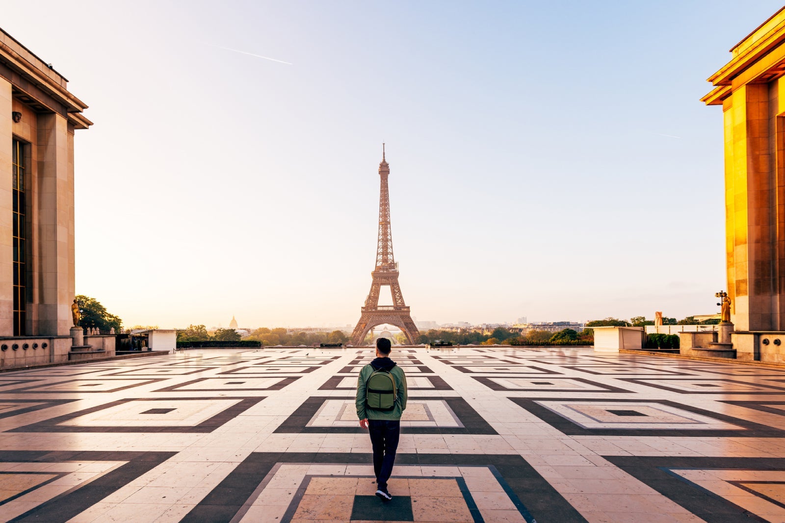 Tourist walks toward the Eiffel Tower in Paris, France