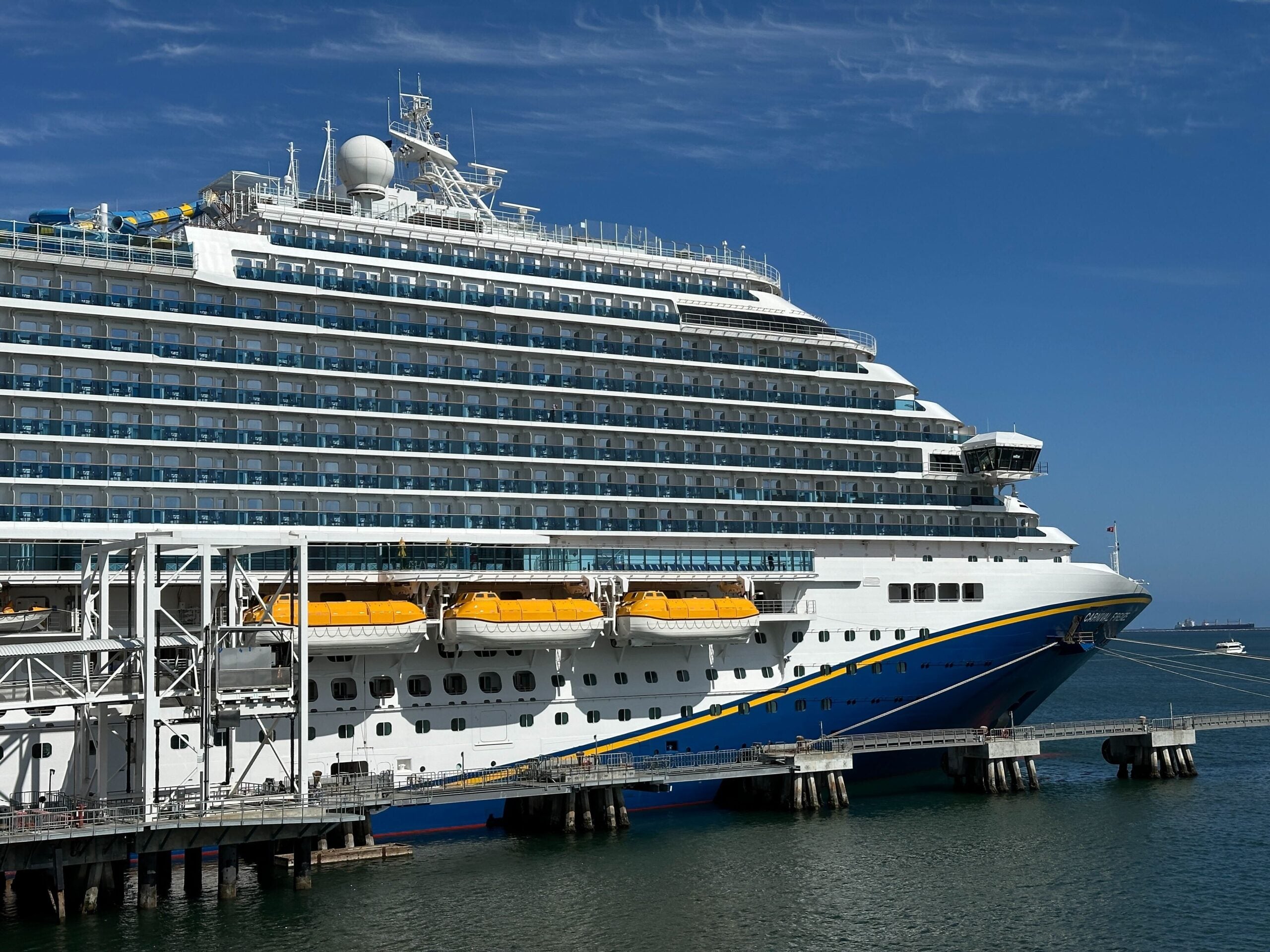 The Carnival Firenze anchored to a dock