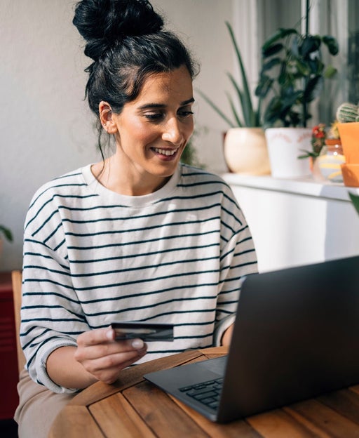 Woman using a credit card at her desk
