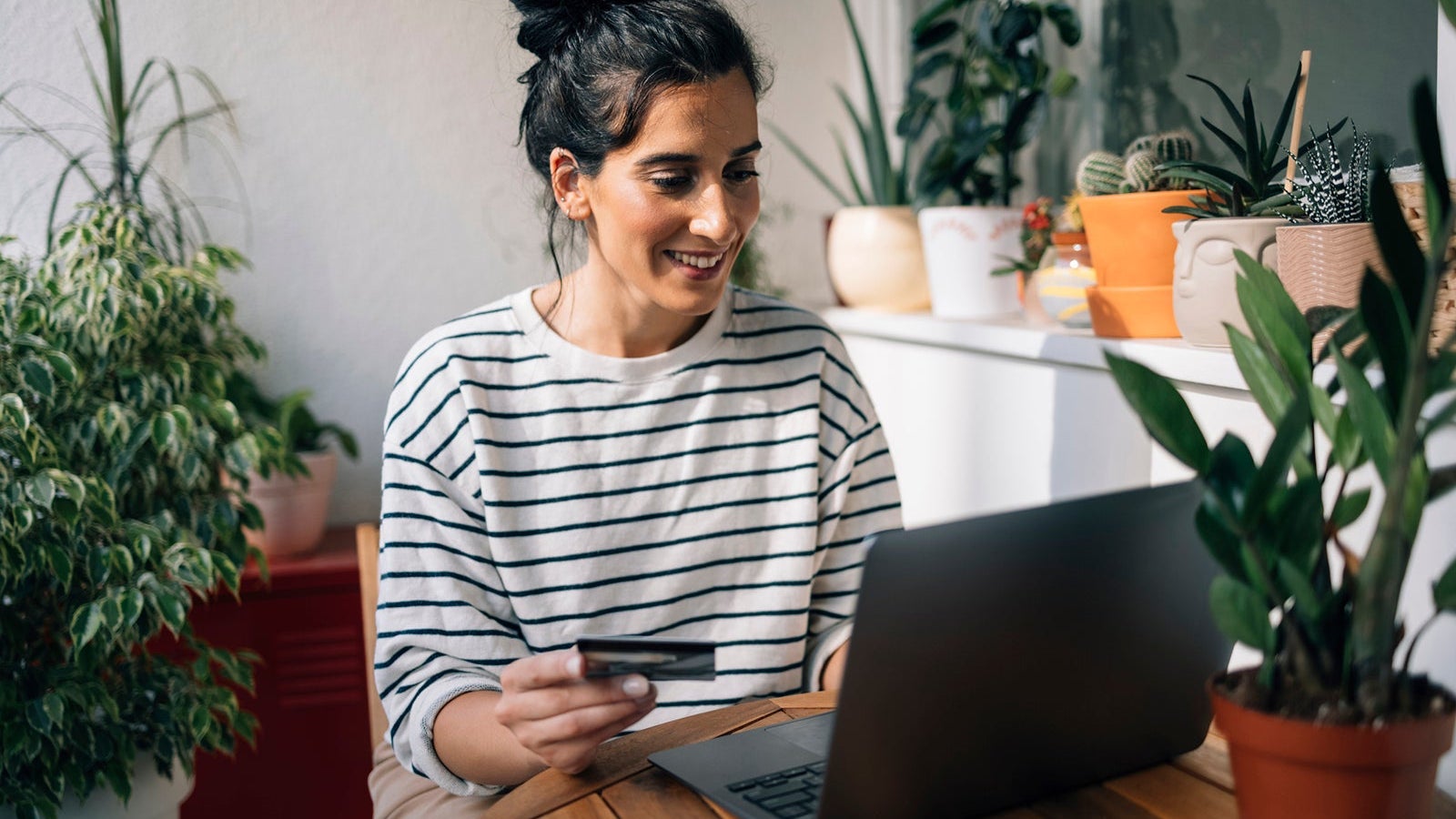 Beautiful Young Woman Shopping Online Using her Credit Card