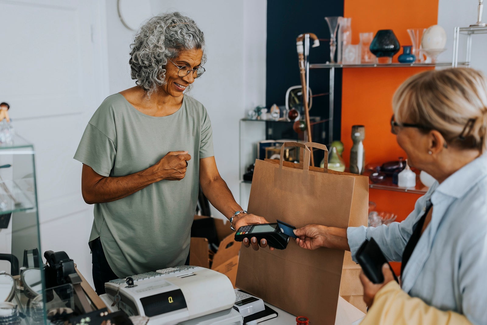 Woman making a purchase at a store counter