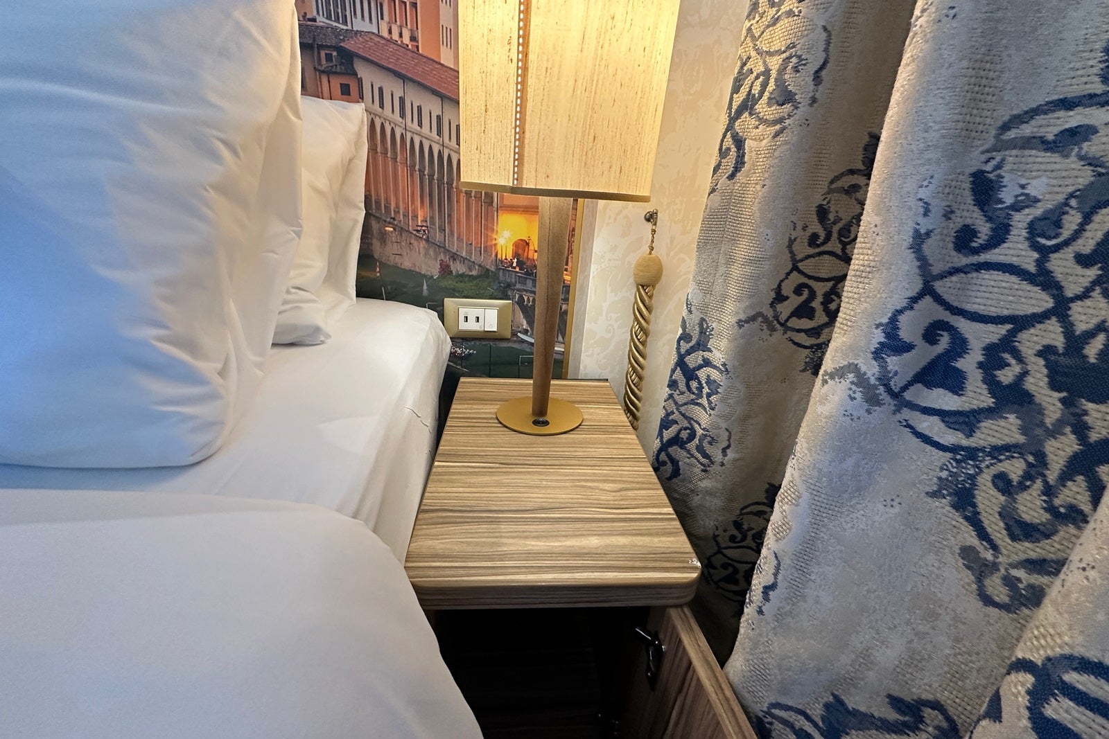 A nightstand beside a bed with USB ports