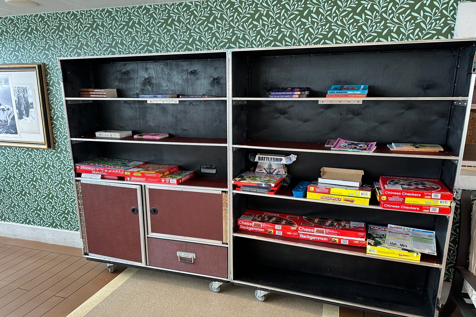 A cart with shelves holding books and board games