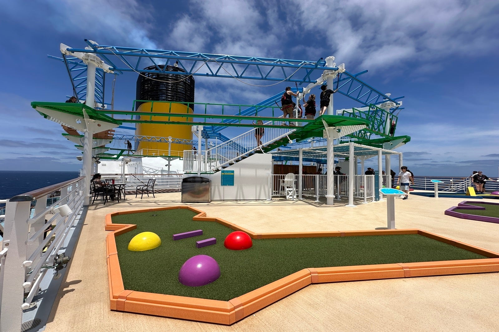 A ropes course and mini-golf course on a cruise ship