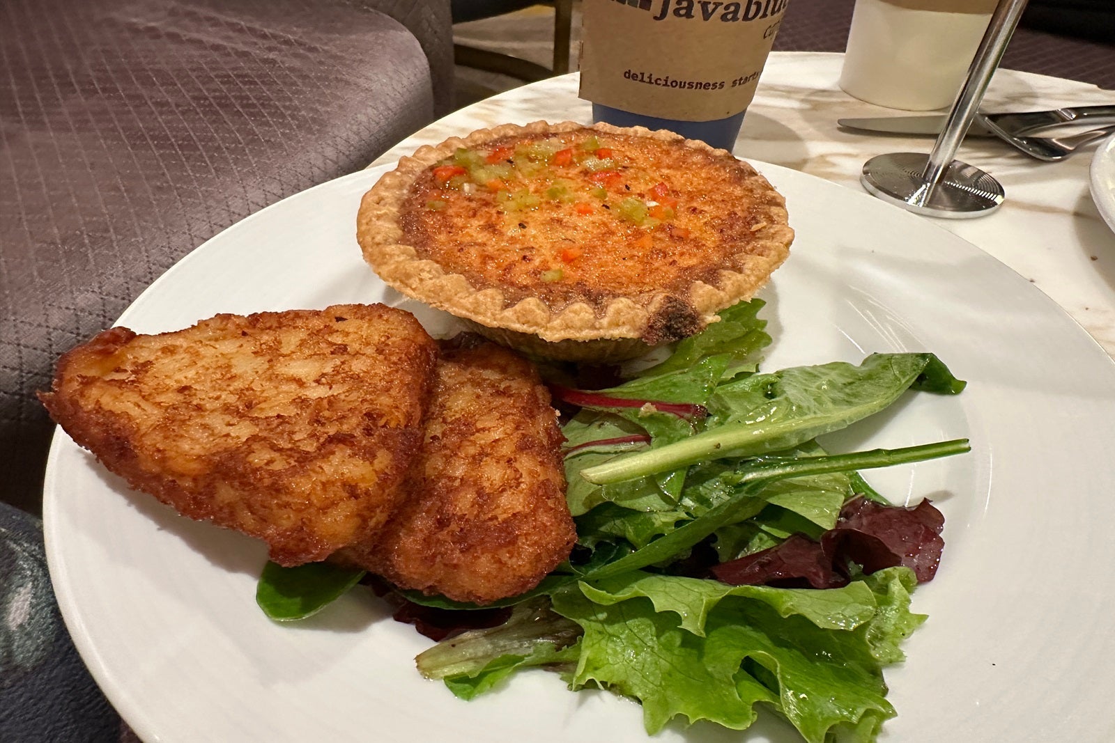 A plate with quiche and hashbrowns at Carnival Firenze's La Terazza restaurant