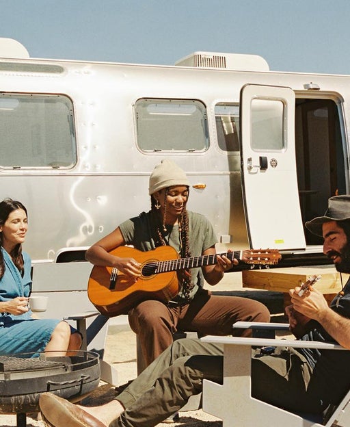 People gathered outside of an Autocamp RV