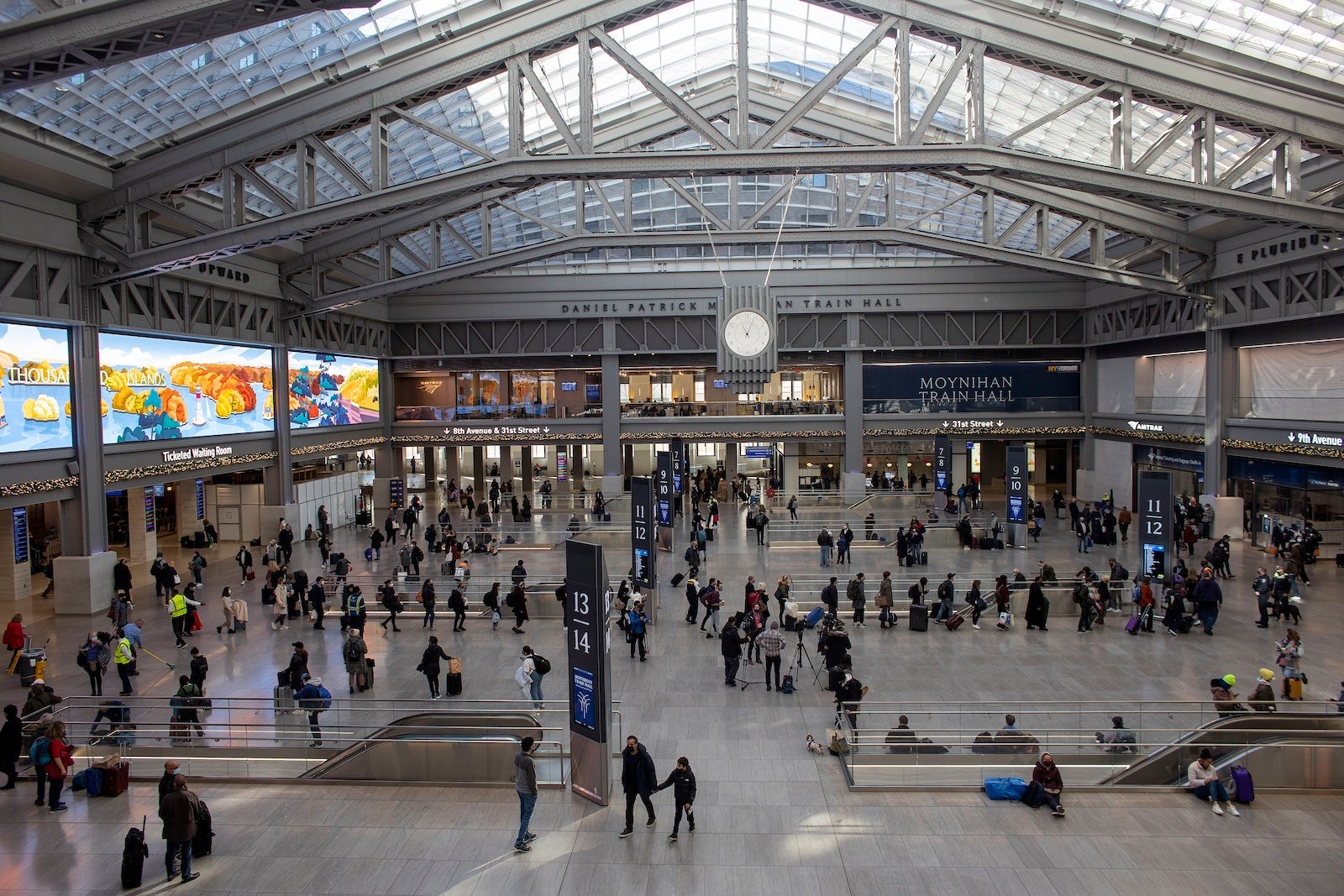 The day before Thanksgiving, holiday travelers arrive at the newly built Moynihan train hall in Penn Station to catch Amtrak trains out of the city