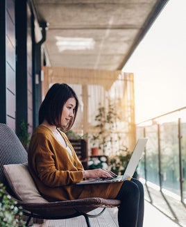 Woman using her laptop outdoors