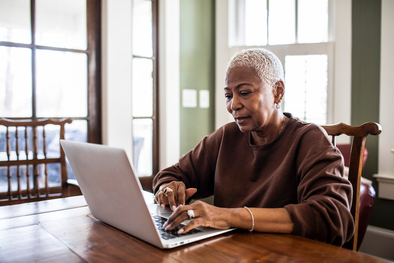 High woman using laptop at home
