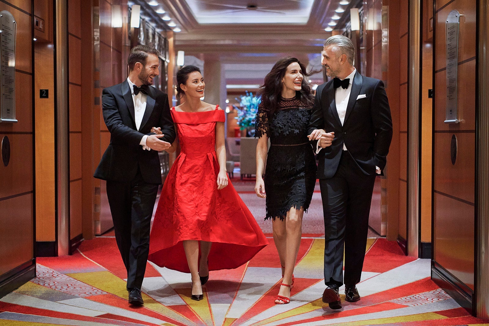 Two male-female couples dressed up for dinner