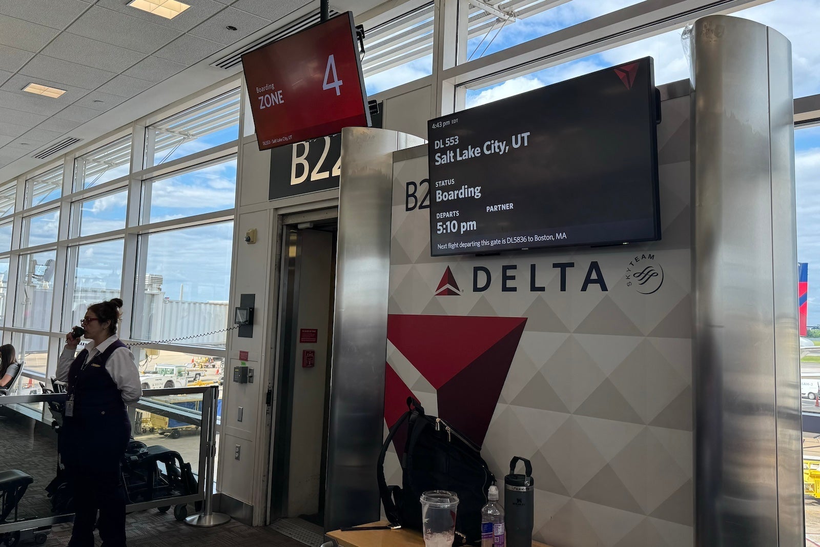 an airport gate with a screen showing that a Delta Air Lines flight for Salt Lake City is boarding