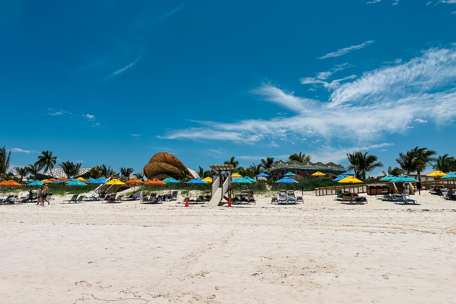 A view of beach chairs, umbrellas and bars on Disney Lookout Cay at Lighthouse Point from the water