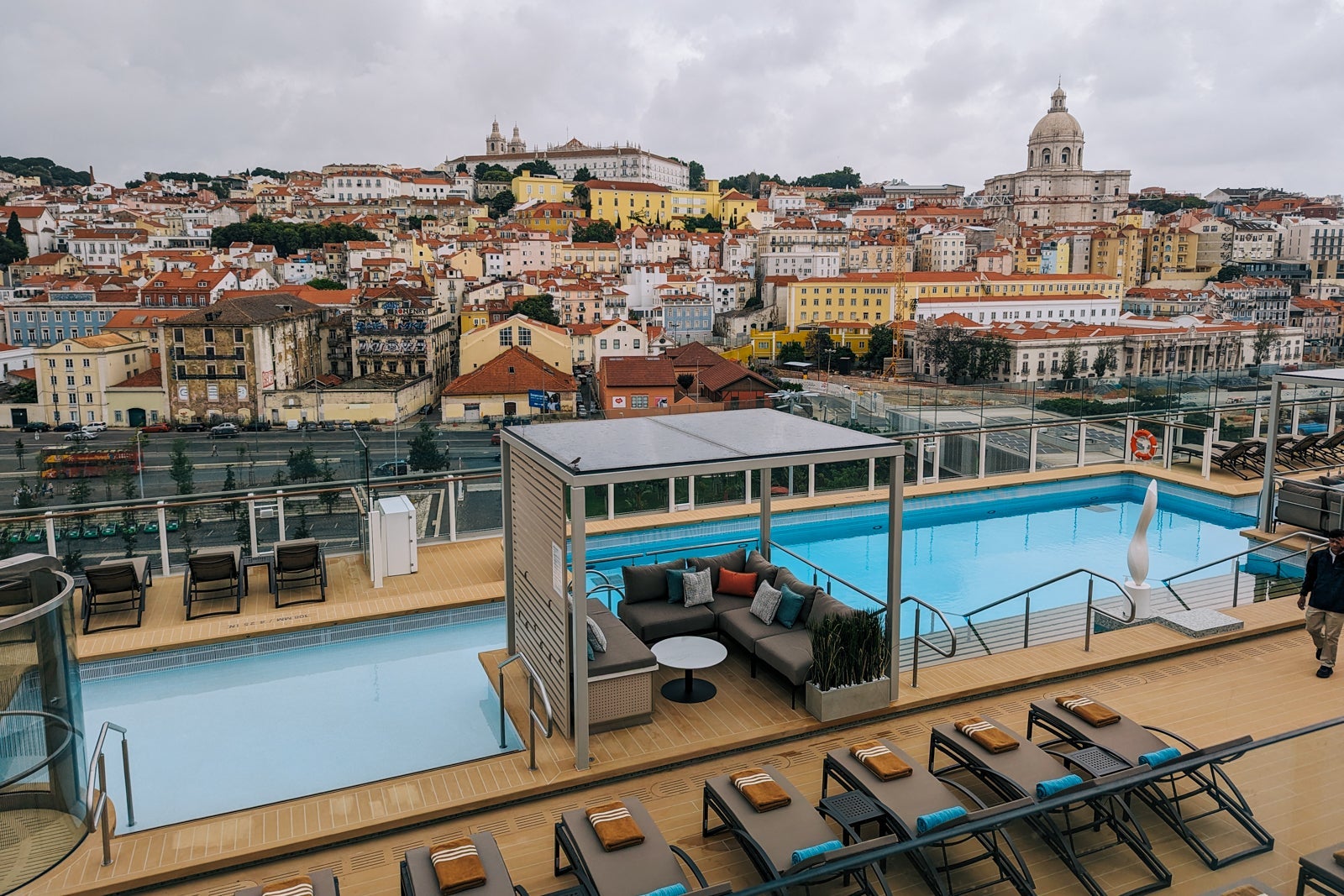 Cruise ship pool set against Lisbon skyline