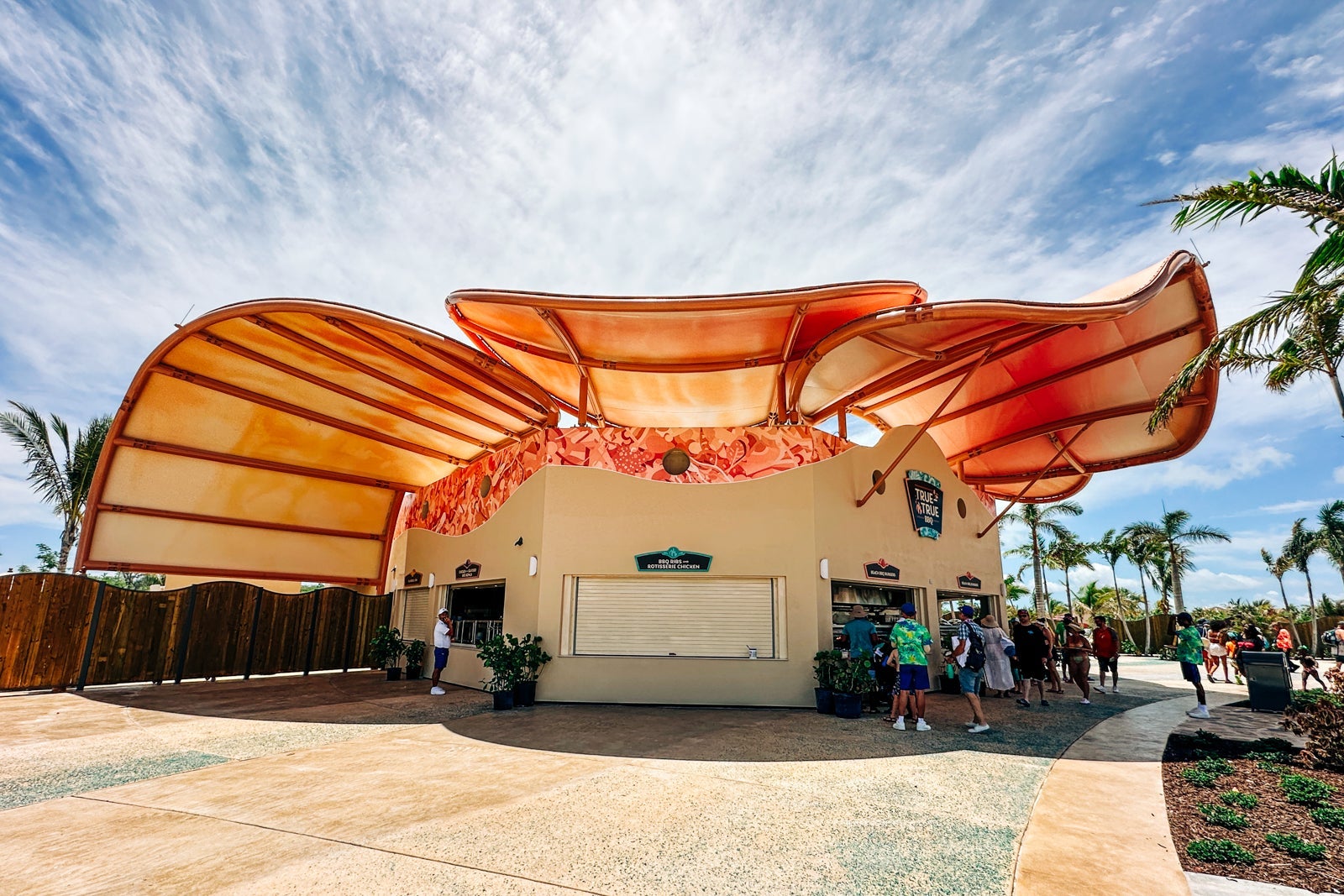 A round building with shell-like shade structures