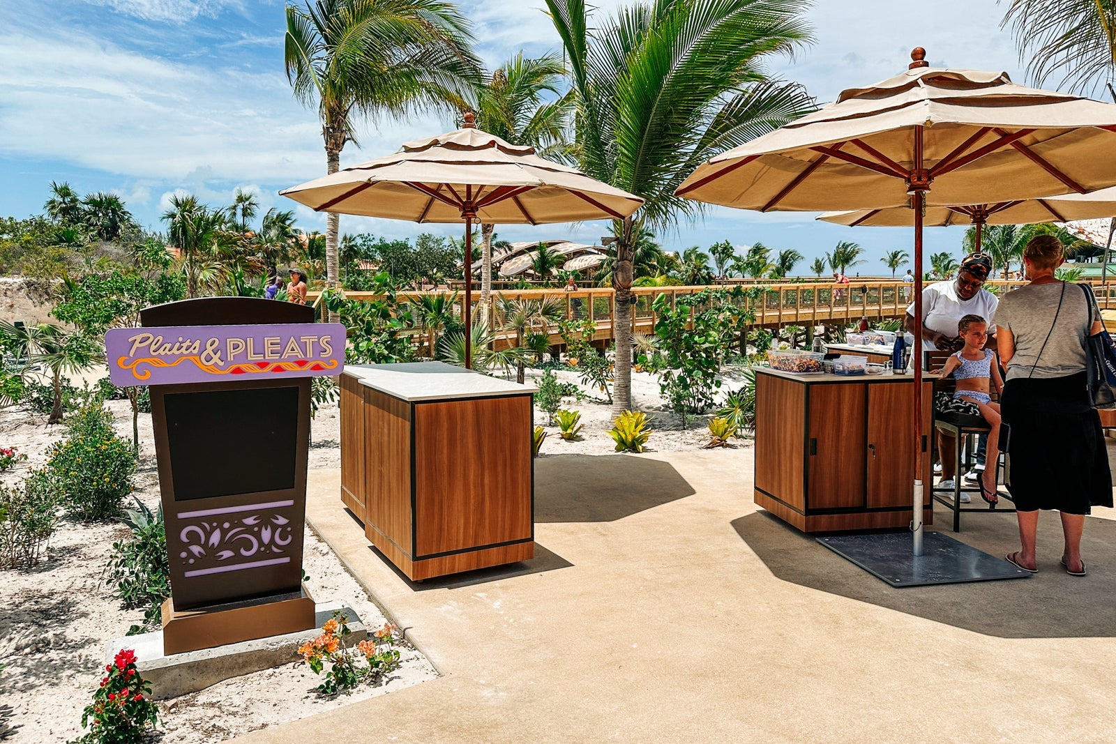 Two small hair-braiding stands with umbrellas