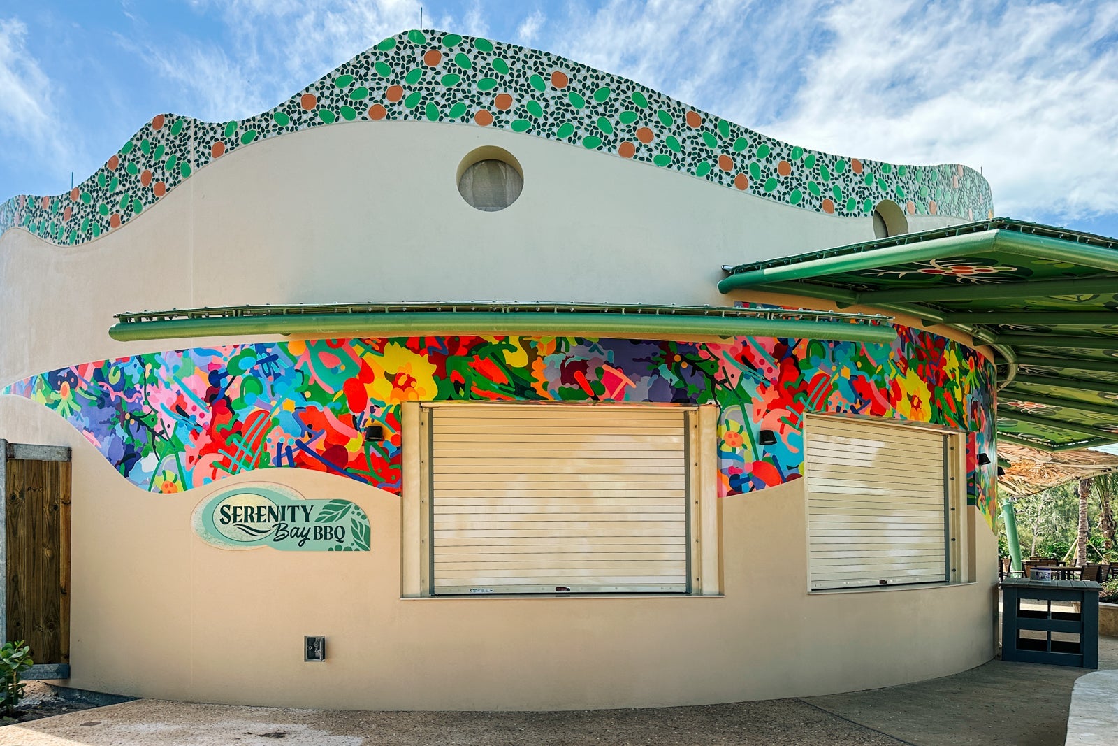 A round building with colorful adornments and walk-up windows that are shuttered