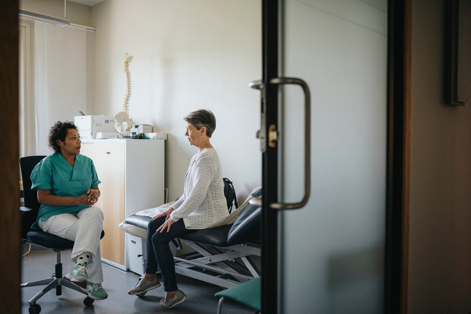 Doctor sitting with female patient