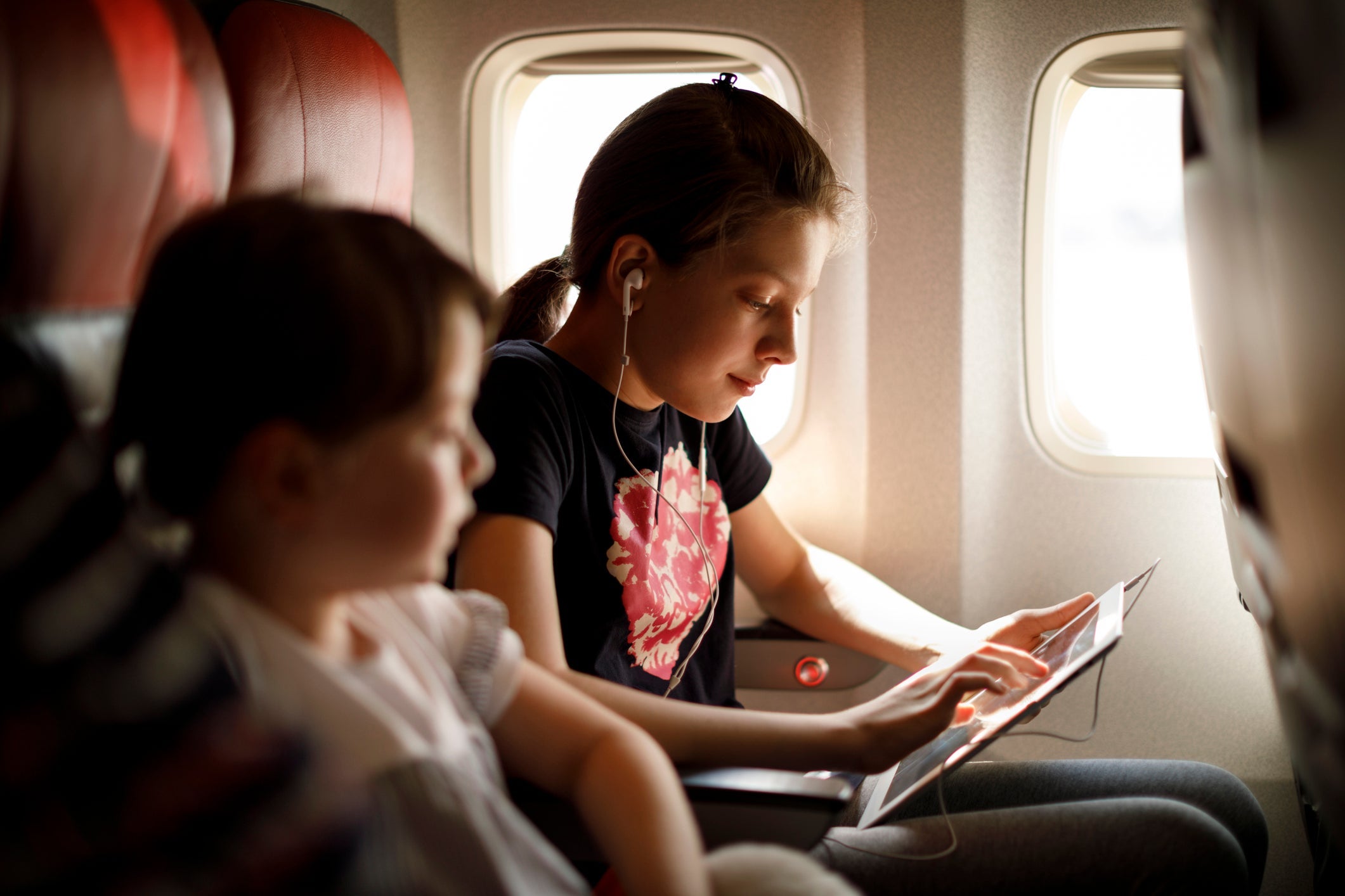 kids using tablet on plane