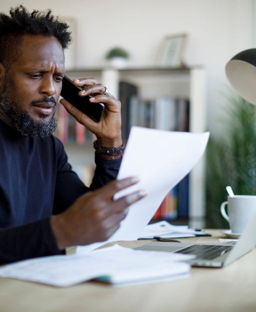 man on phone in front of computer