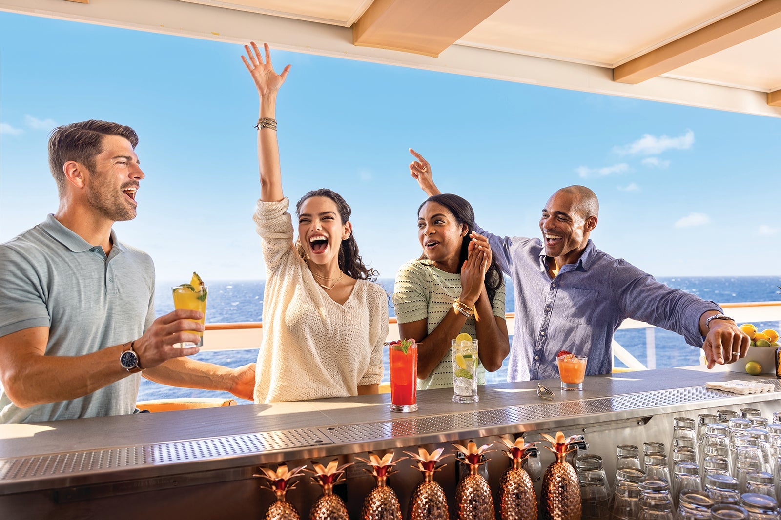 Cruise passengers celebrating at cocktail bar