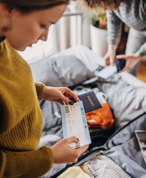 Two women packing for a trip.