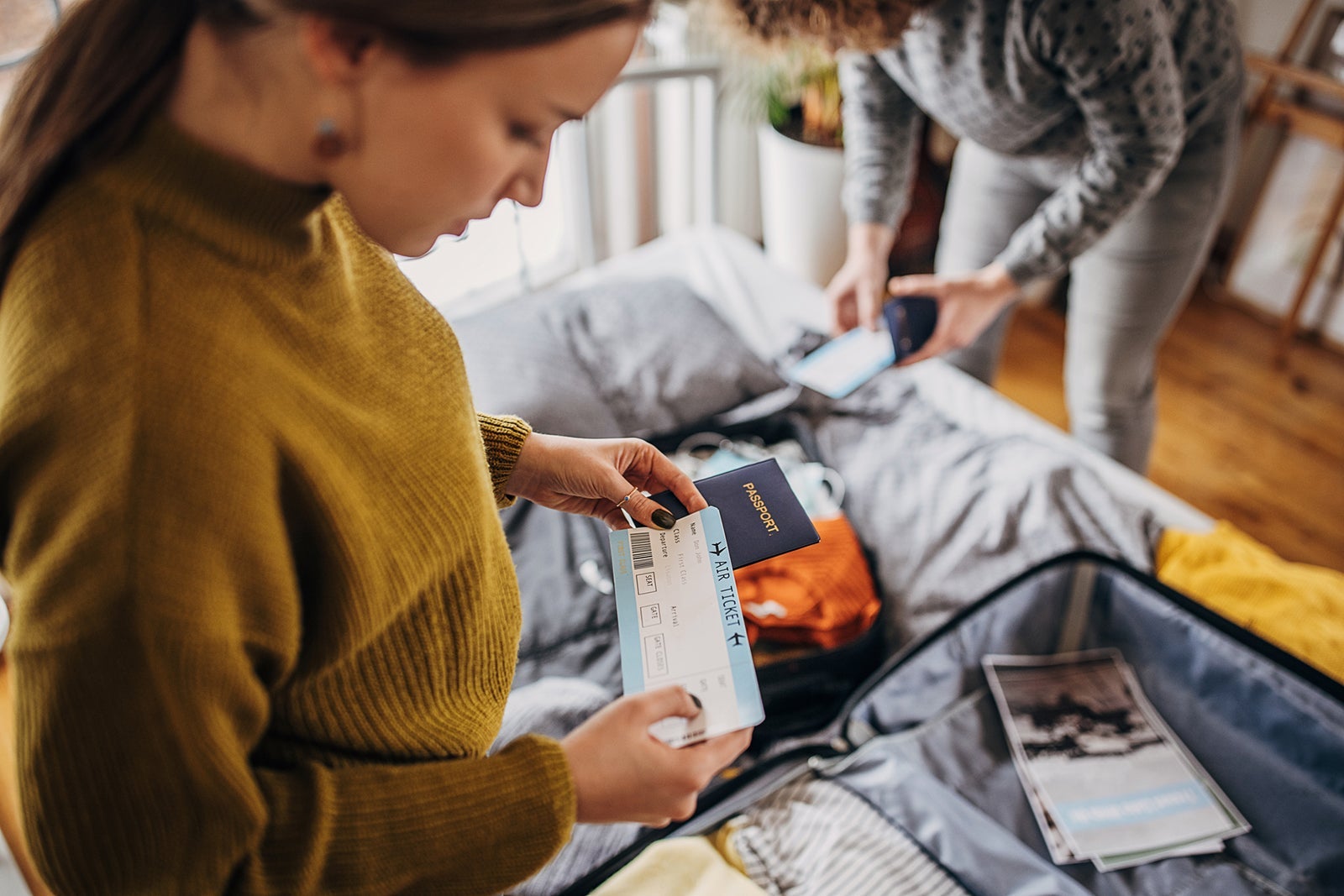 Two women packing for a trip.