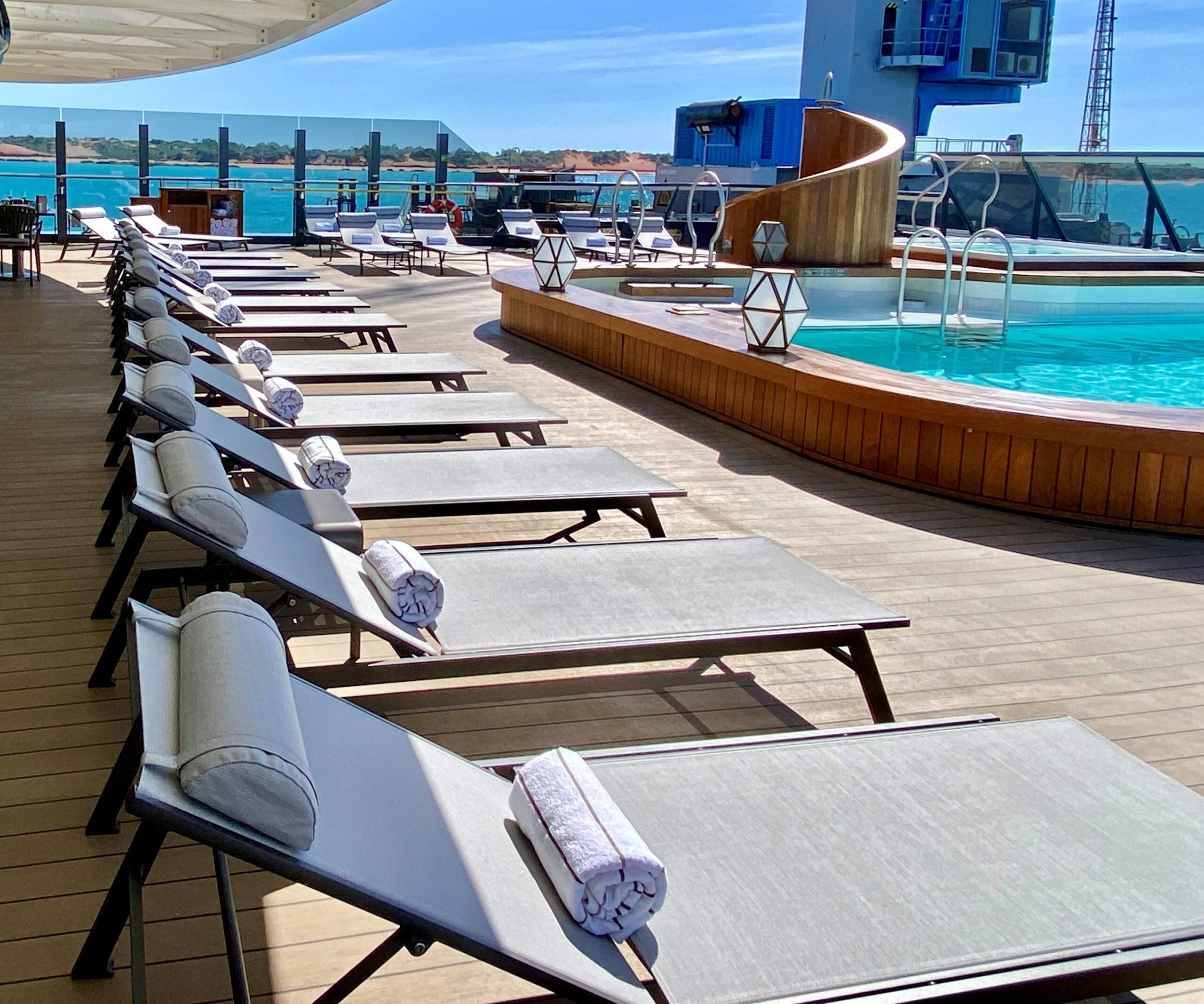 Lounge chairs around the pool on Seabourn Pursuit